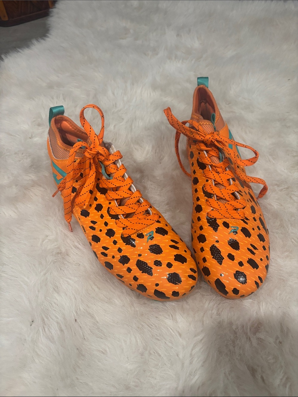 Men’s size 7  Flintstone Orange Leopard cleats
